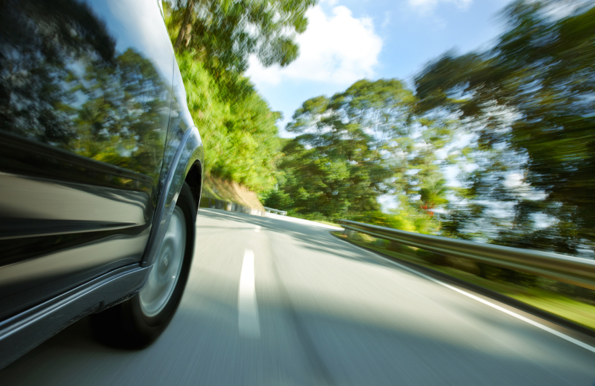 SUV speeding on a narrow curve road